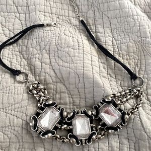 Crystal emerald cut stones and chains with leather.